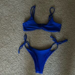 Super cute bikini size small. Tags cut out but never worn. Royal blue color.